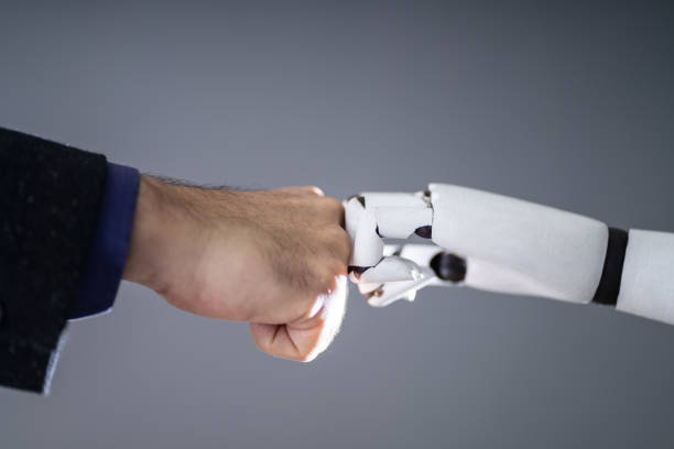 istock Robot And Human Hand Making Fist Bump 1191080378