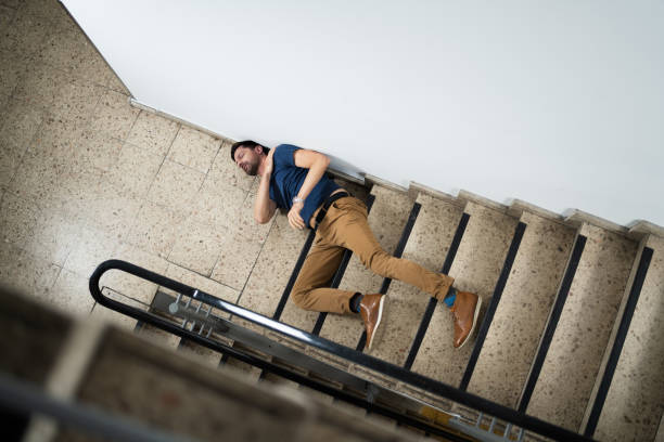 Unconscious Man Lying On Staircase After Slip And Fall Accident