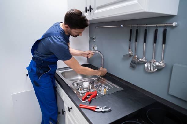 istock Plumber Fixing Faucet In Kitchen 1191080445