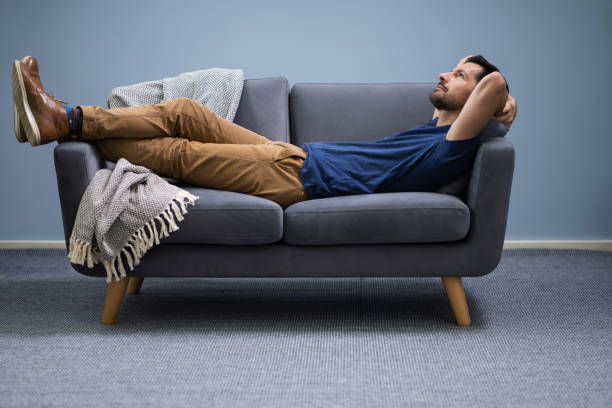 istock Man Relaxing On Sofa At Home 1191080481