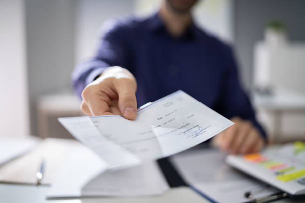 istock Businessperson Hands Giving Cheque 1191080764