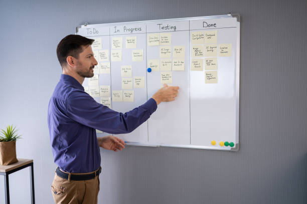 istock Businessman Writing On Sticky Notes 1191080799
