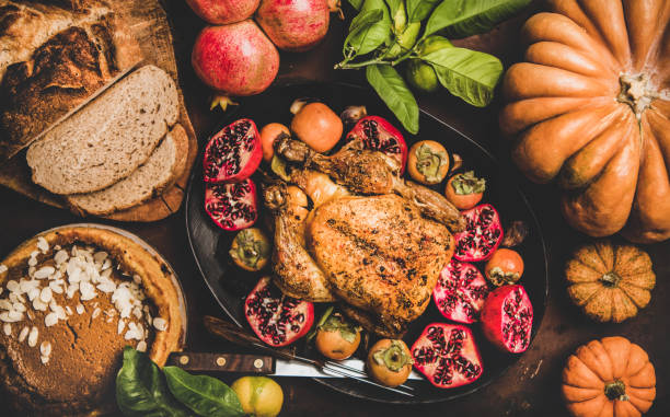 istock Thanksgiving table with roasted turkey and pumpkin pie, top view 1191080970