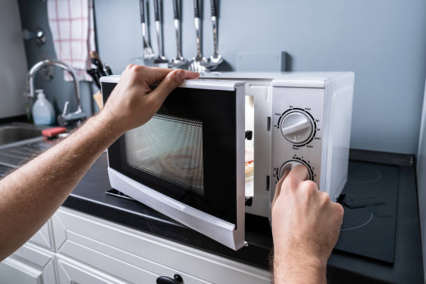 istock Man Preparing Food In Microwave Oven 1191081116