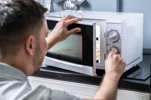 istock Man Preparing Food In Microwave Oven 1191081123