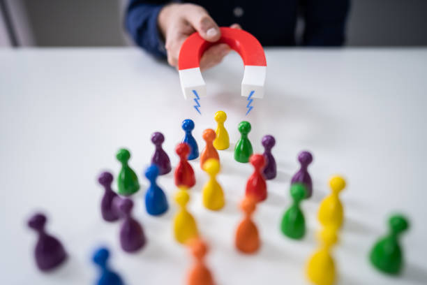 istock Magnet Attracting Colored Pawns 1191081770
