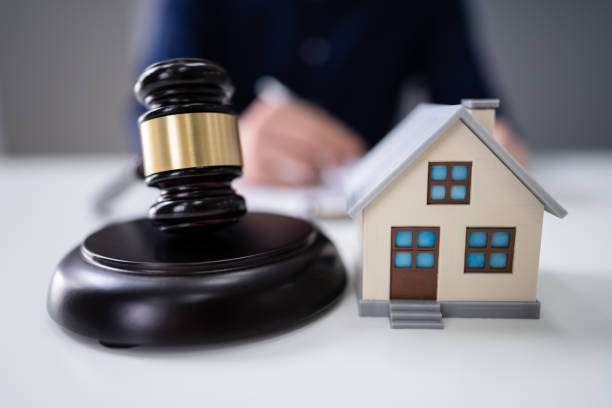 istock Judge Striking Gavel Near House Model 1191081780