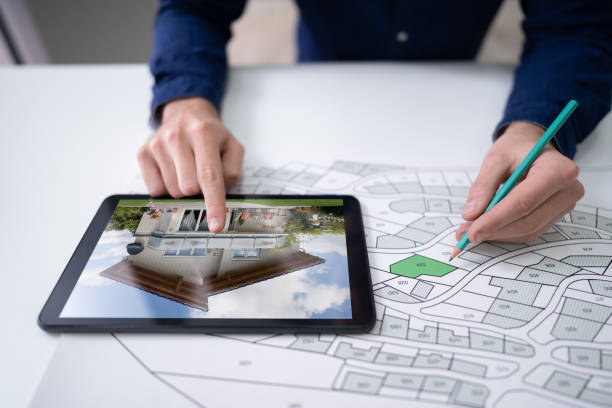 istock Hand Holding Pencil Over Cadastre Map New Tablet 1191081802