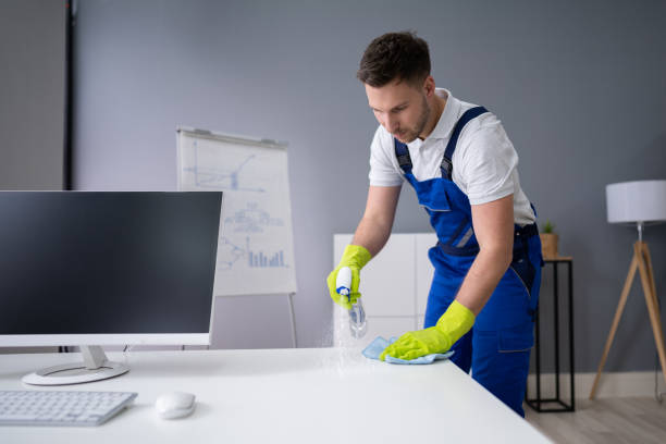 istock Man Cleaning The Glass Office Desk With Rag 1191081830