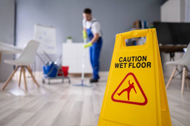 Janitor With Mop Cleaning Office Close-up Of Man Cleaning The Floor With Yellow Wet Floor Sign carpet factory photos stock pictures, royalty-free photos & images