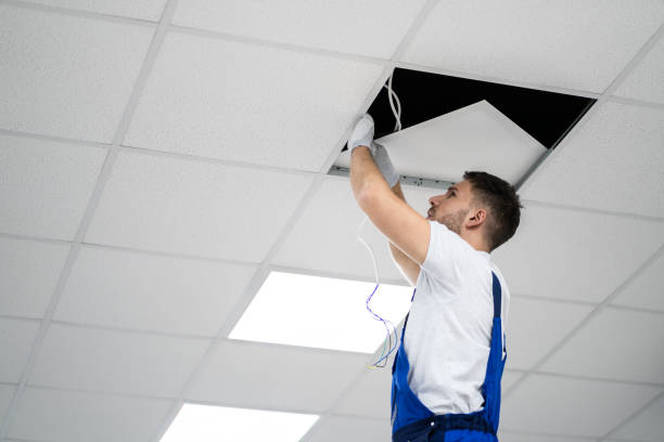 istock Electrician On Stepladder Installs Lighting To The Ceiling 1191081875