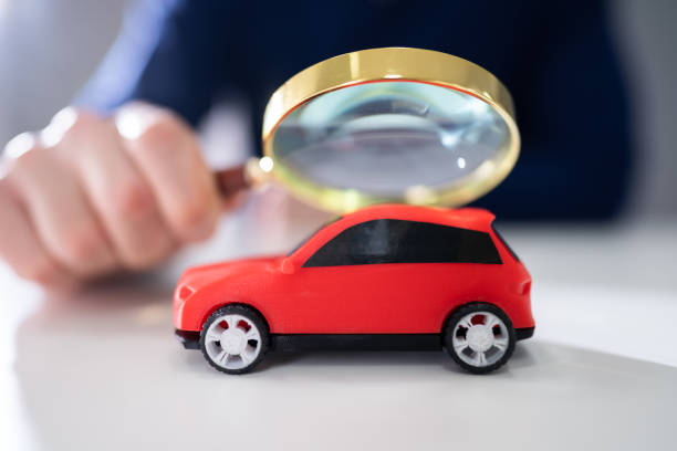 istock Businessman Holding Magnifying Glass Over Car 1191082077