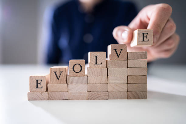 istock Person's Hand Placing Last Alphabet Of Word Evolve 1191082085
