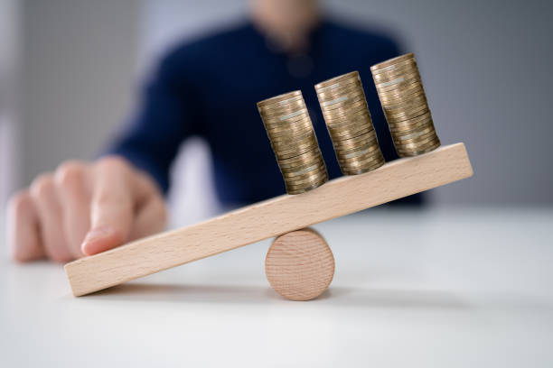 istock Businessperson Balancing Increasing Stacked Coins With Finger 1191082101