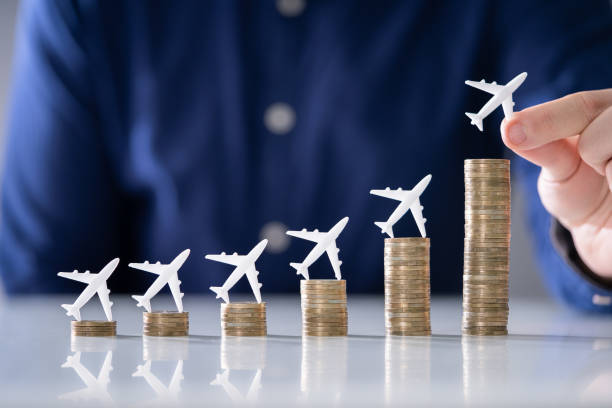 istock Human Hand Placing Small Airplane On Increasing Stacked Coins 1191082105