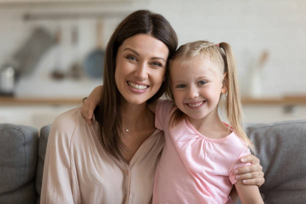 istock Affectionate single mom and child daughter embracing looking at camera 1191083756