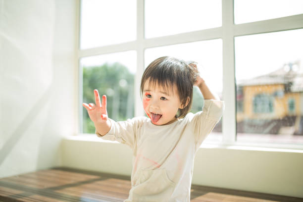 istock Cute little girl paiting her on face. 1191084941