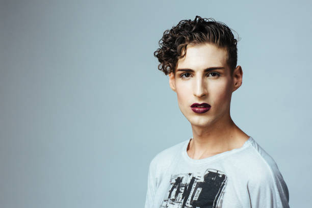 Close up portrait of a young model with make up and dark red lips Close up portrait of a young model with make up and dark red lips man gay stock pictures, royalty-free photos & images