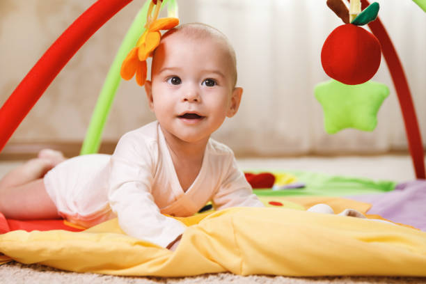 istock Cute baby is playing on the activity mat 1191085119