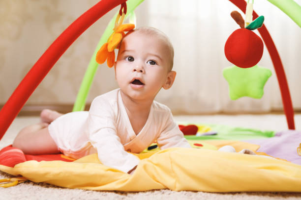 istock Cute  baby is playing on the activity mat 1191085314