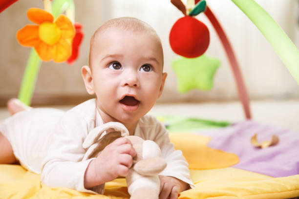 istock Cute  baby is playing on the activity mat 1191085884