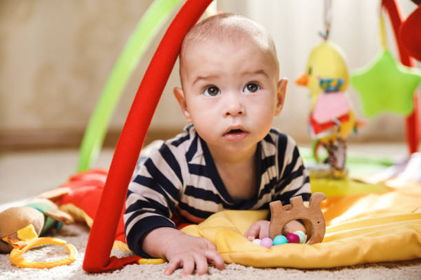 istock Cute  baby is playing on the activity mat 1191085906