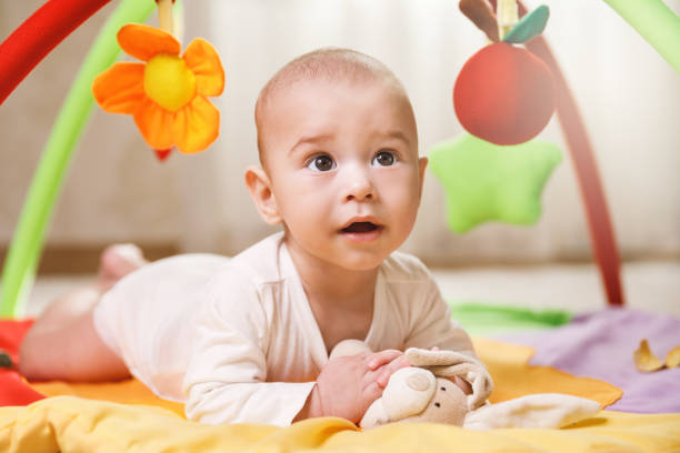 istock Cute  baby is playing on the activity mat 1191086051