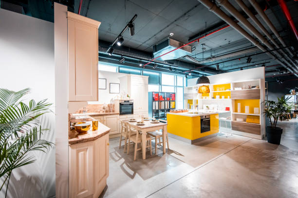 istock Two contemporary kitchen designs using warm wooden and yellow colors in a home design and improvement store 1191088310