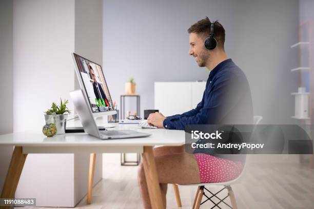 Businessman Attending Video Conference On Computer Stock Photo - Download Image Now - Underwear, Men, Meeting