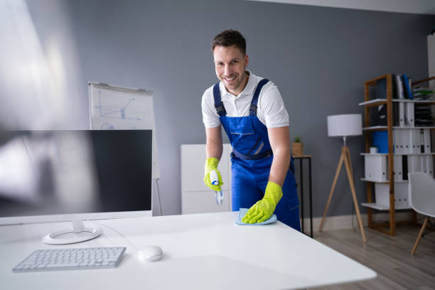 istock Man Cleaning The Glass Office Desk With Rag 1191088489
