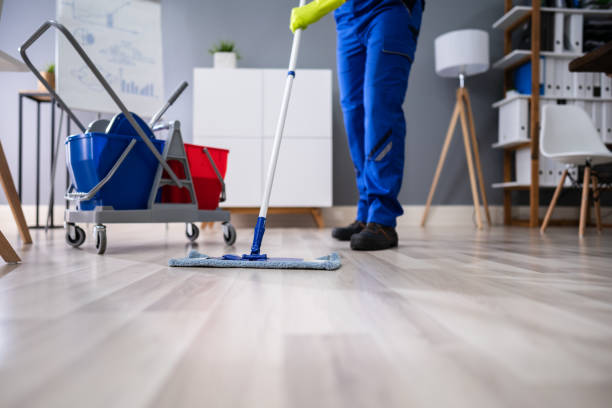 istock Happy Male Janitor Mopping Floor In Office 1191088490