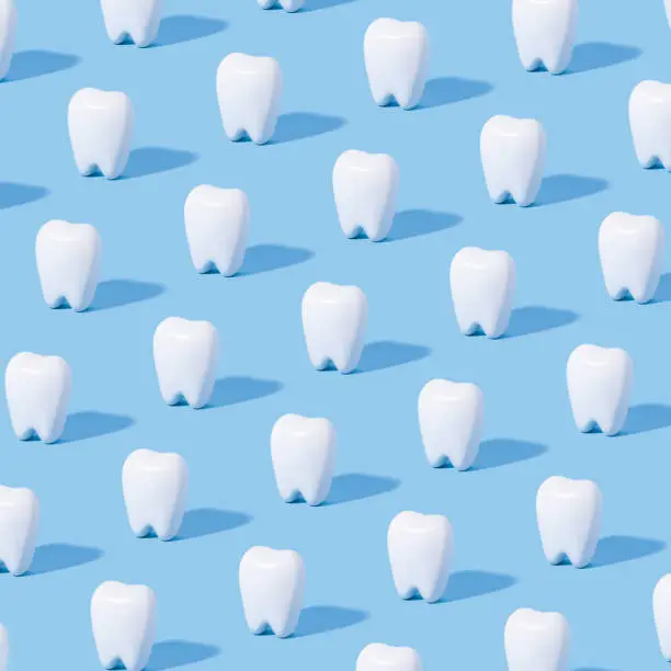 Photo of White teeth pattern on a blue paper background.