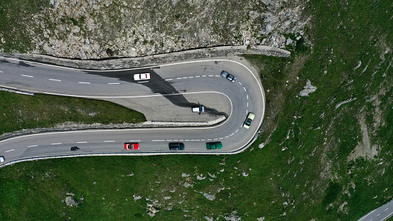 Aerial view of winding road with cars in mountains. Furka Pass, Switzerland.