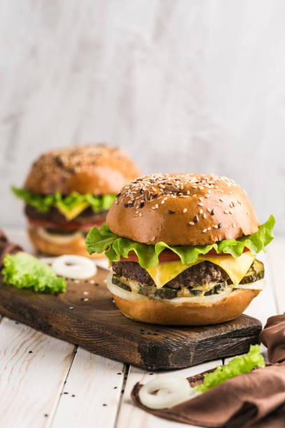 istock Classic Burger with beef Patty, fresh lettuce, onions, pickles, cheddar cheese and tomatoes. 1191091378