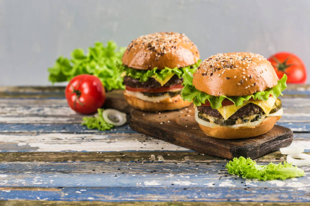 istock Classic Burger with beef Patty, fresh lettuce, onions, pickles, cheddar cheese and tomatoes. 1191091382