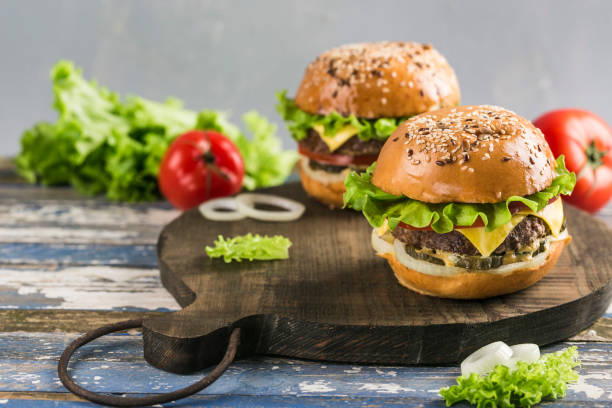 istock Classic Burger with beef Patty, fresh lettuce, onions, pickles, cheddar cheese and tomatoes. 1191091515