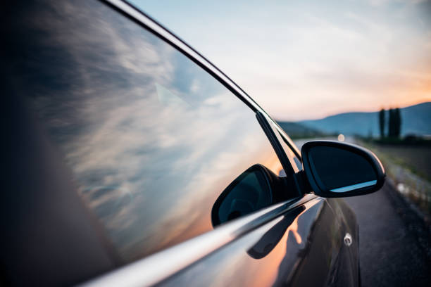 Mirror view of car with sunset stock photo