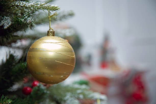 istock Branches Christmas gold ball . New year background decorations Christmas white tree green nature Christmas gold ball . Christmas ball hanging star abov . Red on a branch of a New Year's fir-tree . 1191095478