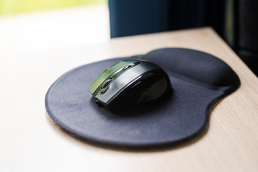 Black computer mouse on a pad
