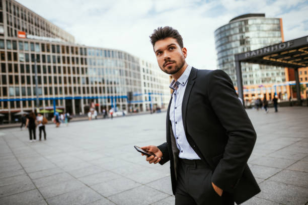 istock Millennial businessman using mobile phone in Potsdamer Platz, Berlin 1191104693