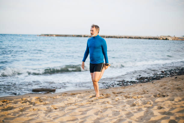 istock Man cooling down after the  morning jogging on the beach 1191109671