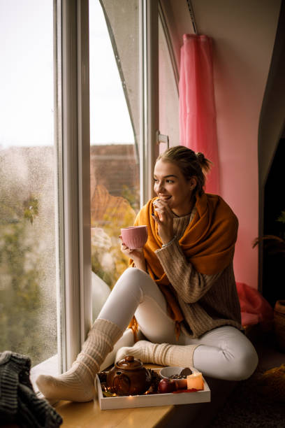 Relaxing on the window and enjoying warm tea