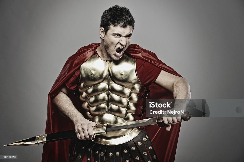 Lone legionary soldier in costume ready for war Roman Legionary Soldier and Gladiator Holding Stock Photo