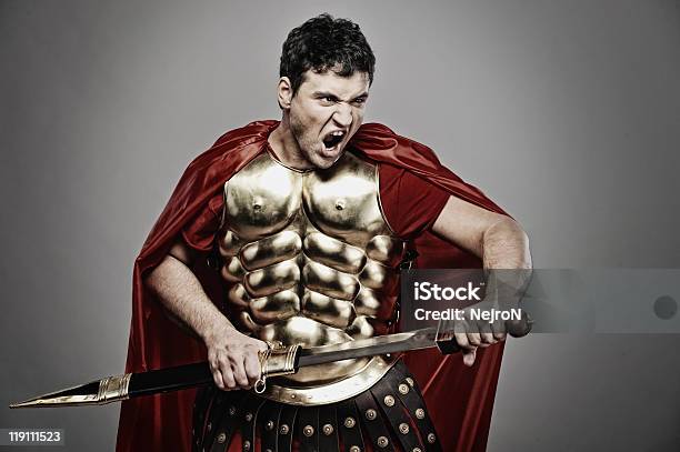 Lone Legionary Soldier In Costume Ready For War Stock Photo - Download Image Now - Holding, Men, Sword