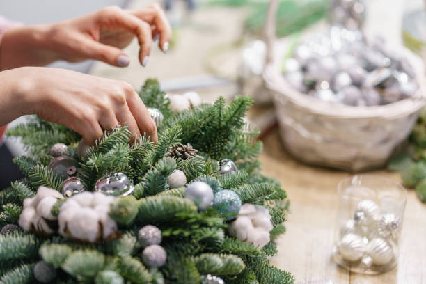 istock A woman decorates a Christmas arrangement. Hands close-up. Master class on making decorative ornaments. Christmas decor with their own hands. The new year celebration. Flower shop 1191116951