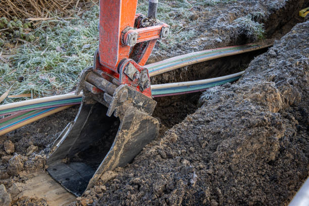 istock an excavator digging a trench to lay a high-speed Internet DSL cable 1191117240
