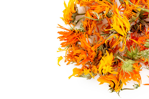 Heap of dry marigold calendula flowers isolated on a white background.