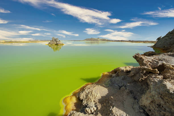 Inside Dallol volcano crater at Danakil Depression Ethiopia The volcanic explosion crater of Dallol in the Danakil Depression in Northern Ethiopia. The Dallol crater was formed during a phreatic eruption in 1926. This crater is known as the lowest subaerial vulcanic vents in the world. The surreal colors are caused by green acid ponds and iron oxides and sulfur. danakil depression stock pictures, royalty-free photos & images