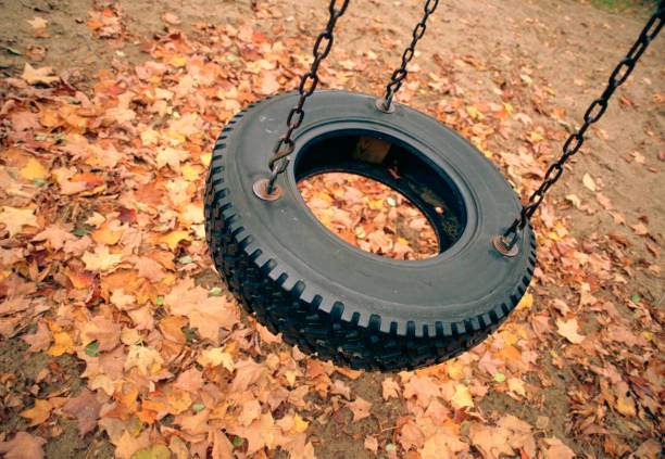 Close up of tire Swing in Park at Autumn.