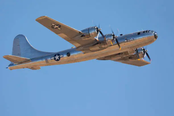Very close side view of a rare WWII bomber (B-29 Superfortress) flying